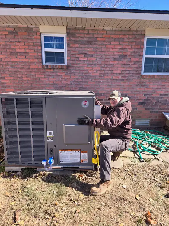 An Osage Air technician working at a packaged unit